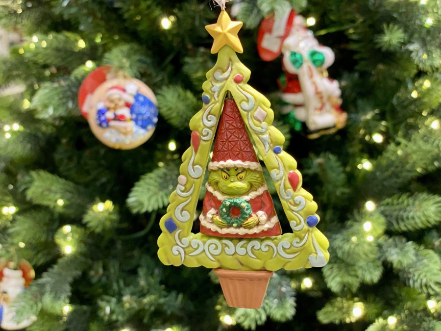 The Grinch is at it again, taking a Christmas tree! This playful ornament shows the Grinch's mischievous side, reminding us of his naughty antics in Whoville.