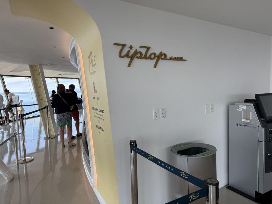 Inside the Space Needle’s Tip Top cafe, diners enjoy an elegant setting with modern décor, glass floors, and panoramic windows