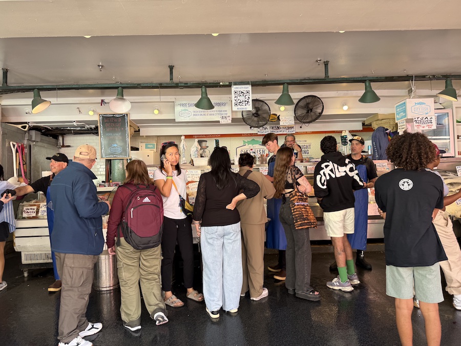 City Fish Company staff preparing seafood orders behind a counter.