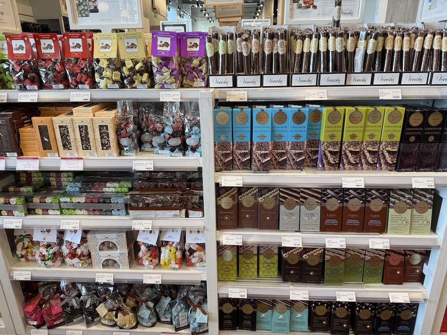 Colorful Italian candies displayed in cases.