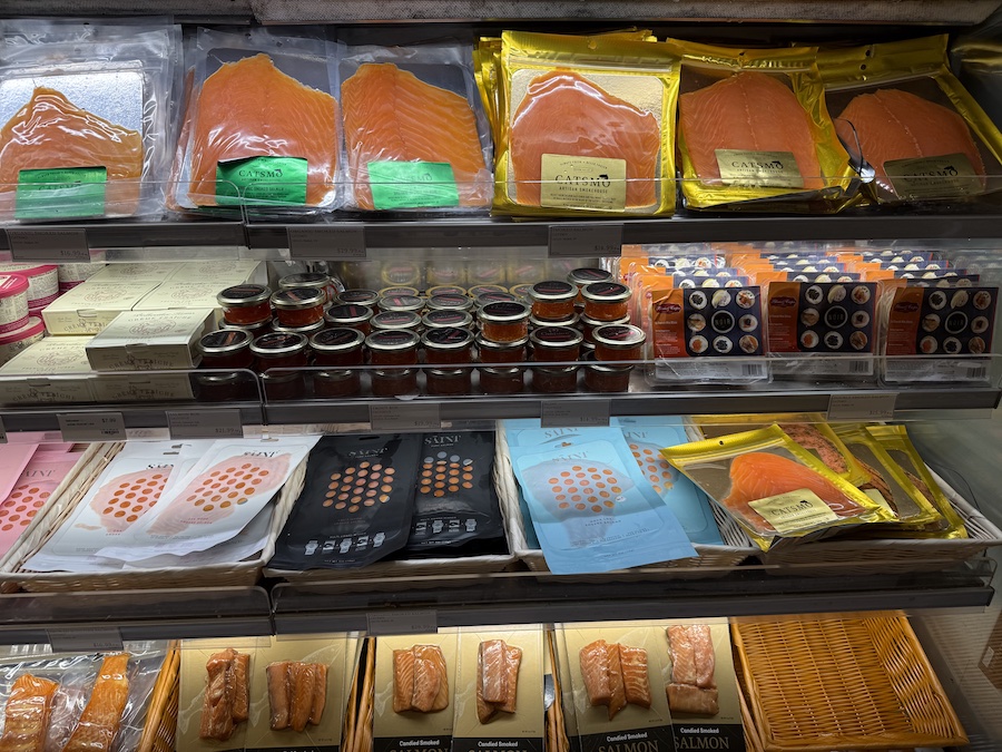 Premium smoked salmon with caviar elegantly displayed at the seafood counter.