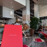 A view of the Eataly dining area with tables filled with guests.