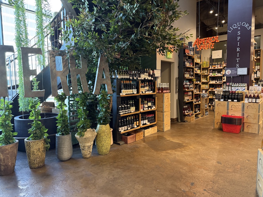 Wine section showcasing Italian reds and whites in wooden racks.
