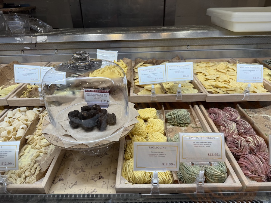Colorful varieties of pasta arranged on the counter.