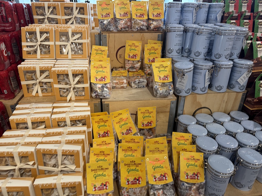 Colorful selection of Italian cookies and candies showcased in jars and boxes.