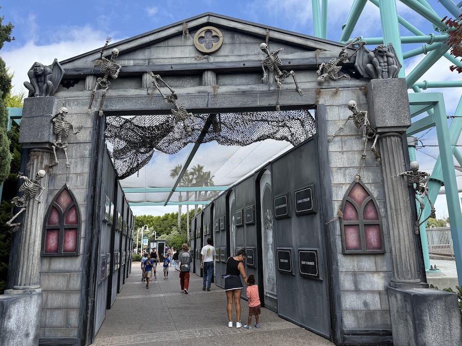 The entrance to a Howl-O-Scream haunted maze at SeaWorld San Diego, decorated with skeletons and gothic-style architecture.