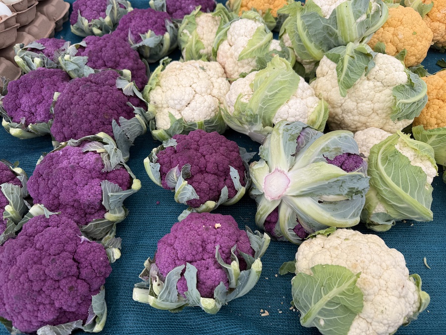 Close-up of cauliflower with crisp green leaves.