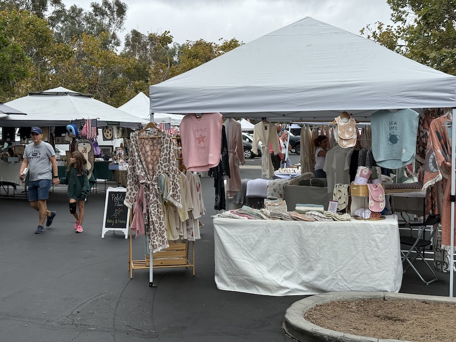 Table with locally made scarves, shirts, and fabric accessories.