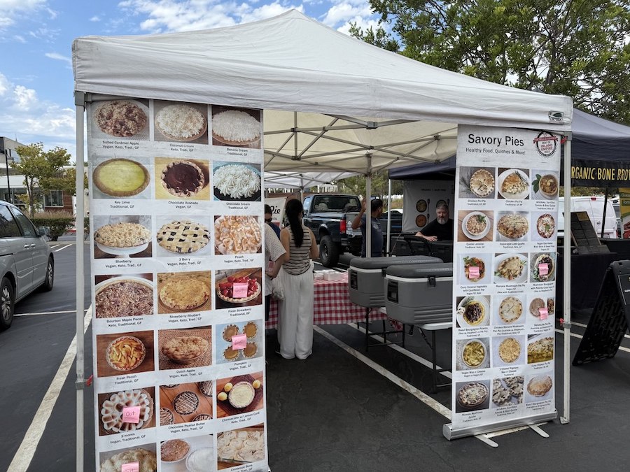 Freshly baked bread and pastries lined up at a bakery stall.