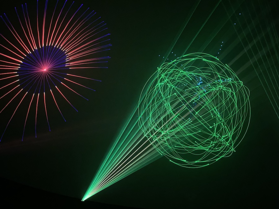 Laser light effects synchronized to a rock concert soundtrack.
