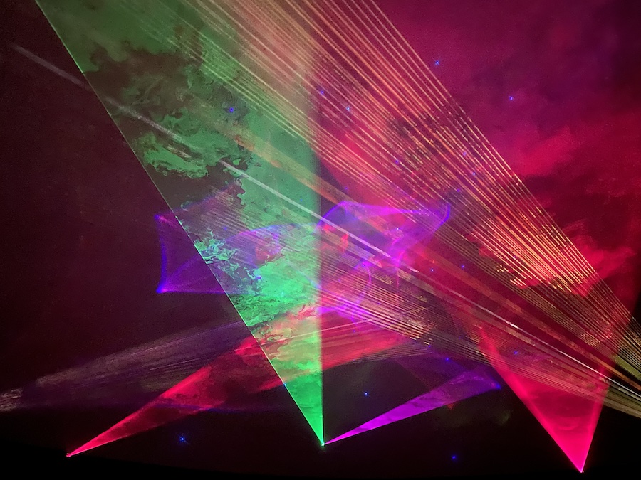 Bright neon shapes swirling across the entire dome surface.