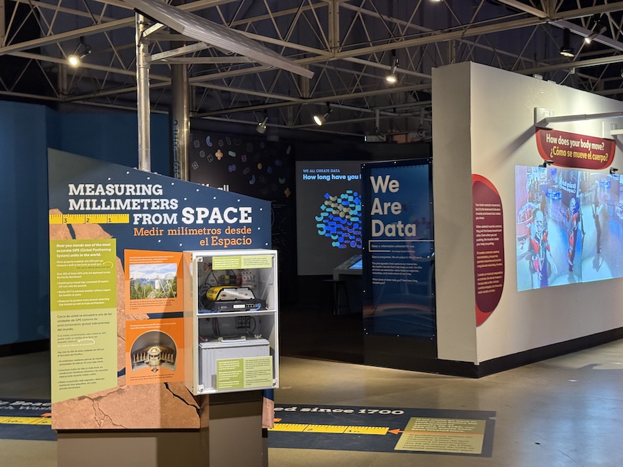 A "We Are Data" exhibit area with various interactive displays, including one on "Measuring Millimeters from Space."