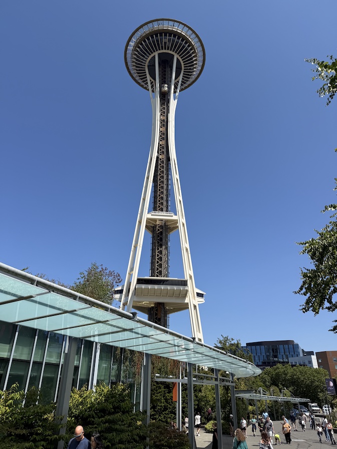 Seattle’s Space Needle towers into a clear blue sky, offering panoramic views from its observation deck.