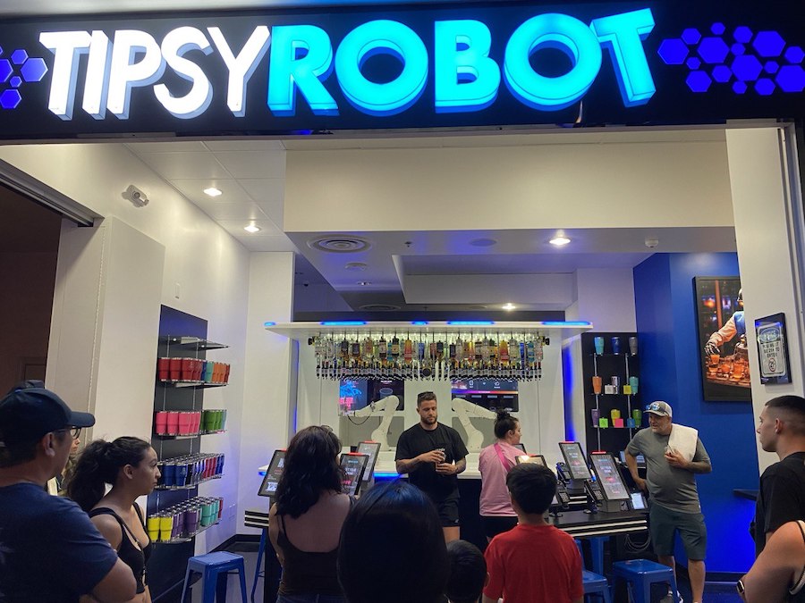 Robotic arms mix colorful cocktails behind the bar at Tipsy Robot in Las Vegas, combining futuristic tech with nightlife fun.