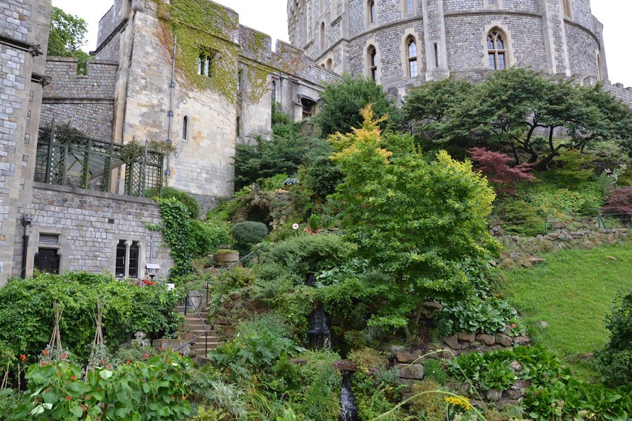 Beautifully maintained greenery and flowerbeds surrounding the medieval walls.