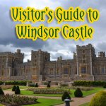 A wide view of Windsor Castle with its stone walls and towers rising above the town.