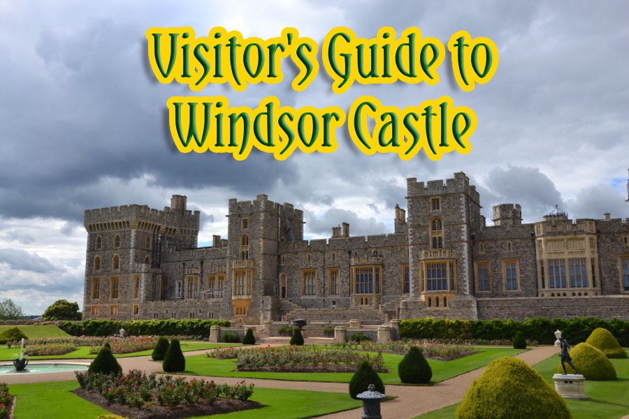 A wide view of Windsor Castle with its stone walls and towers rising above the town.