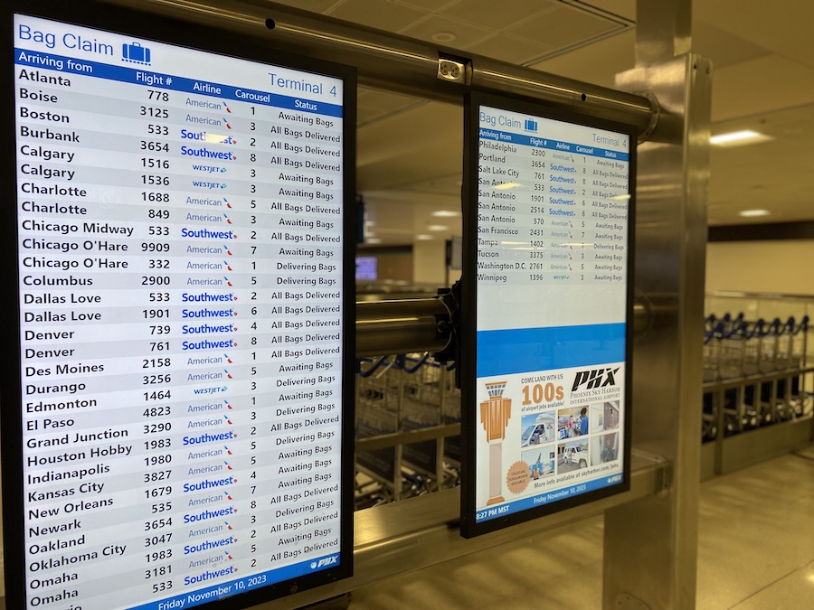 Bright departure board screens displaying flight times and destinations at ATL.