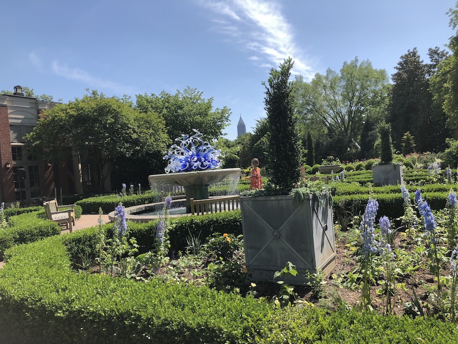 Kids exploring the Lou Glenn Children’s Garden, surrounded by playful fountains and nature play areas.