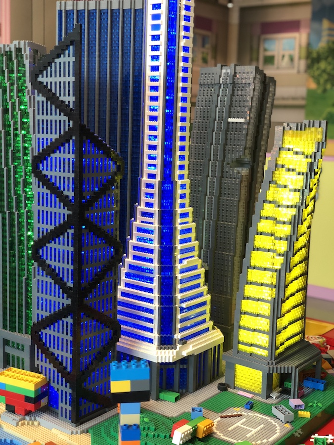 Bright Lego sculptures at the Legoland Discovery Center with children building creations.