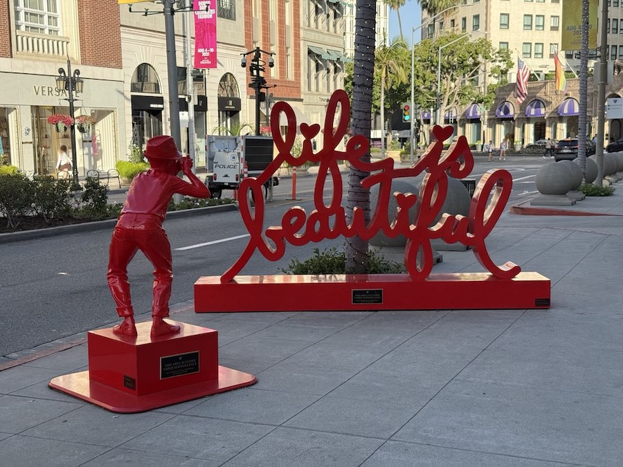 Red statue Life is Beautiful adding color to Beverly Hills shopping.