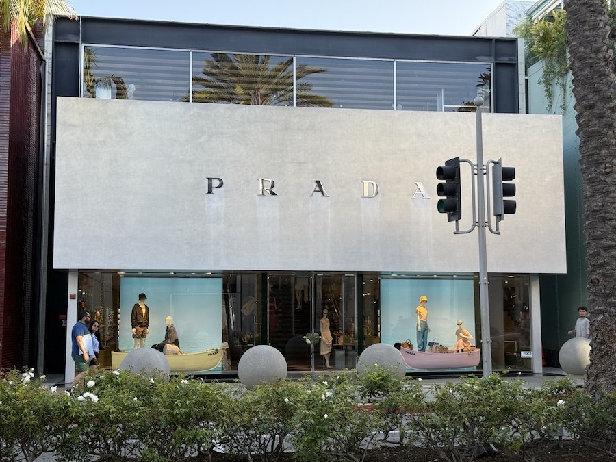 Prada boutique entrance with elegant window displays.