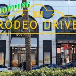 Rodeo Drive luxury boutiques lined with palm trees in Beverly Hills.