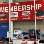 Sign promoting Costco membership benefits inside the store.