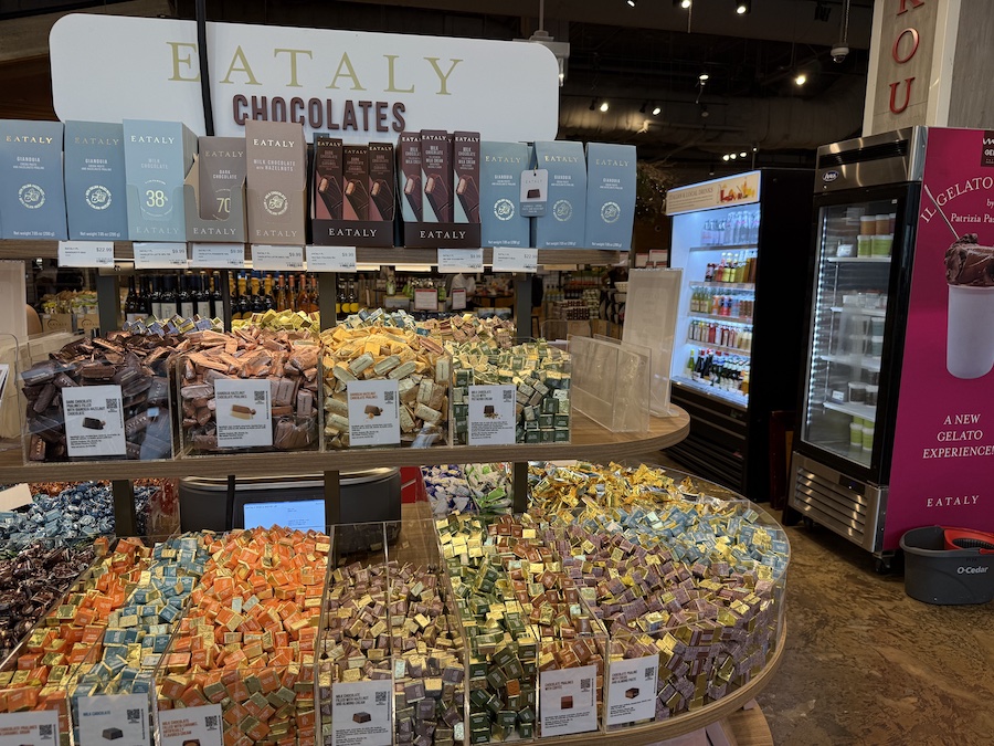 Assortment of Eataly-branded chocolate bars in sleek packaging.