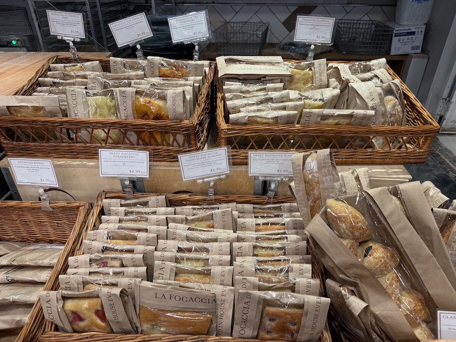 Golden fresh focaccia bread with different flavors.