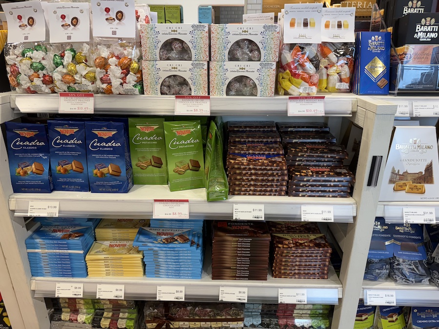 Premium Novi chocolate bars displayed on rustic wooden shelves.