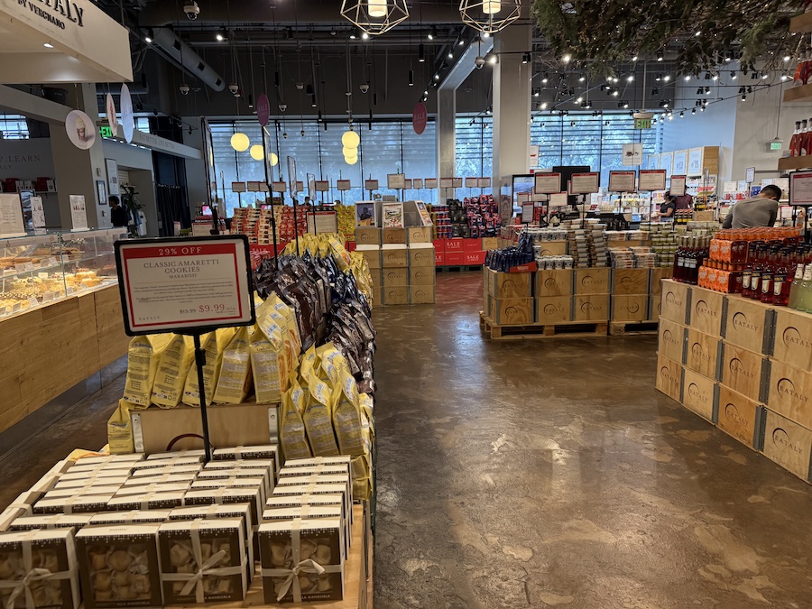 Shelves with promotional products are displayed in the Eataly LA hall.
