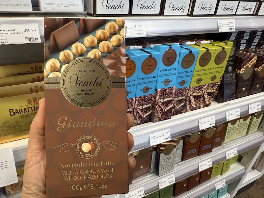 Close-up of Venchi chocolate bars wrapped in elegant gold and colorful packaging.