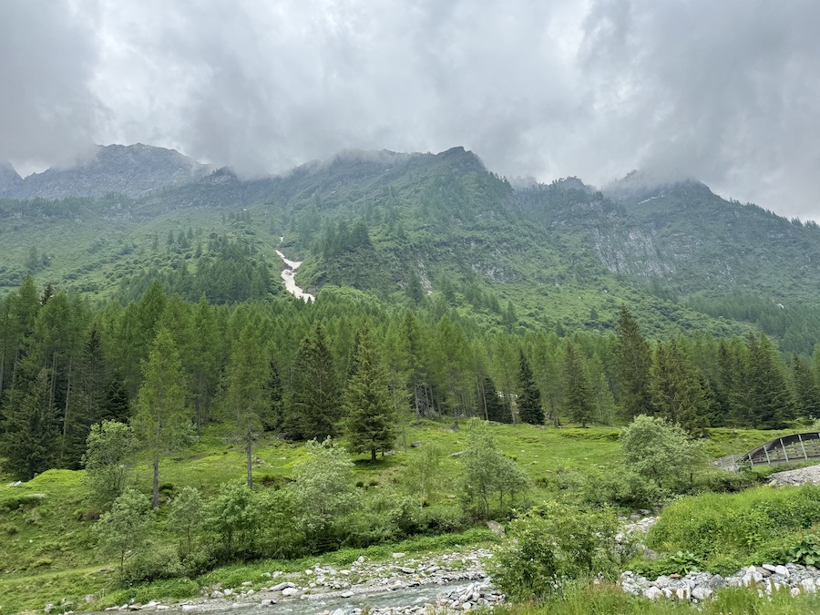 A green mountain valley under a cloudy sky.