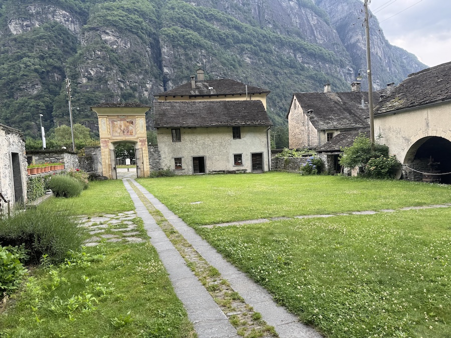 A rural courtyard with traditional Swiss architecture.