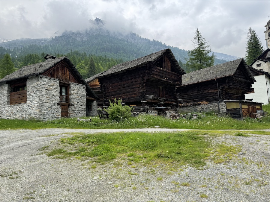 Traditional wooden chalets in a mountain valley.