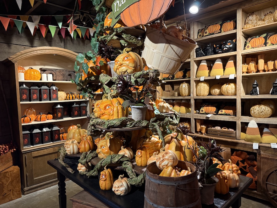 An indoor scene showcases an elaborate, spooky-themed pumpkin display.