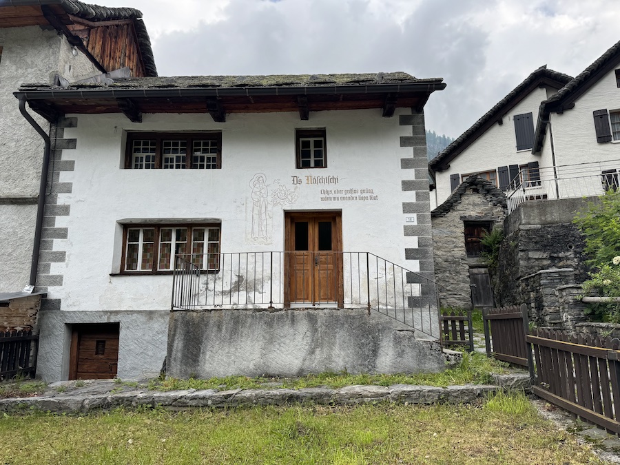 Historic house in Ticino with faded but elegant sgraffito scrollwork.