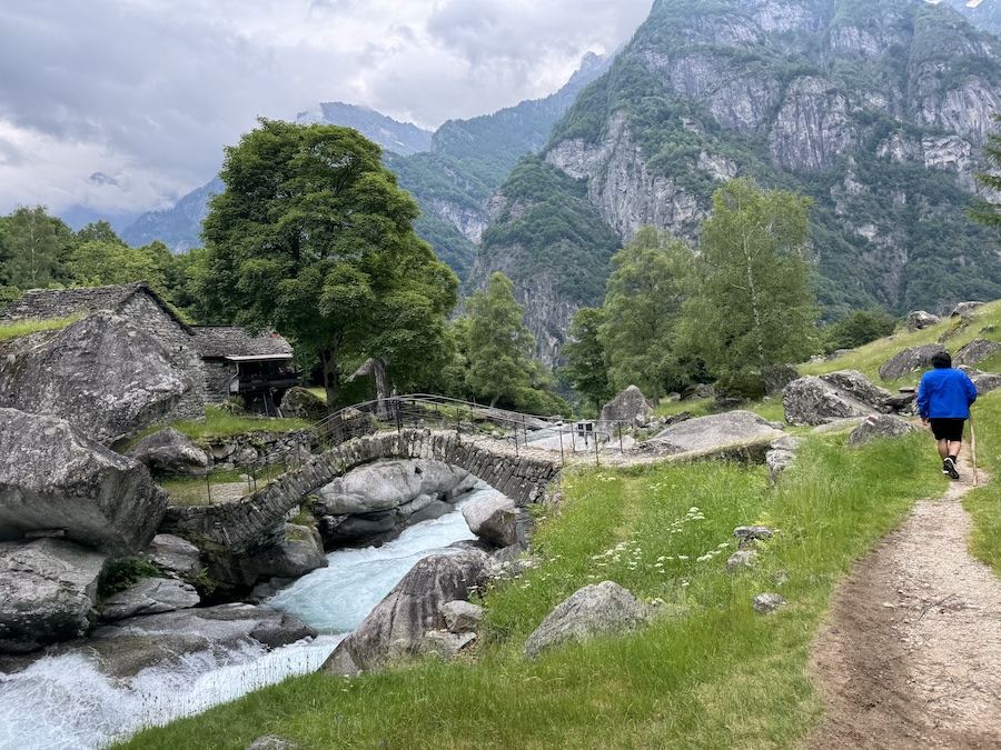 Bavona Valley with dramatic cliffs towering above alpine meadows.