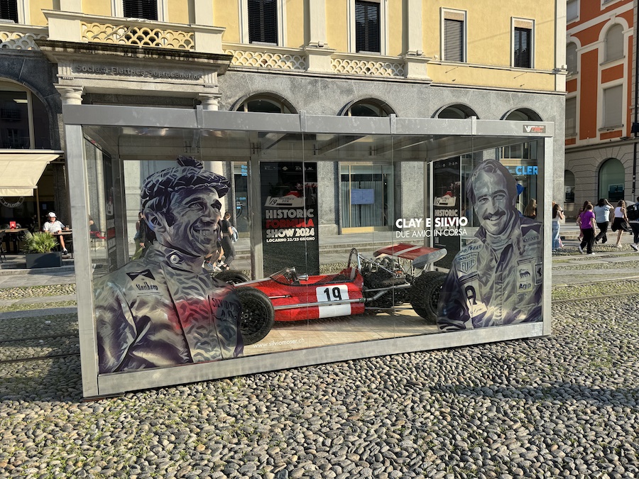 On the cobblestone square of Locarno stands a glass display case with a red Formula 1 racing car.