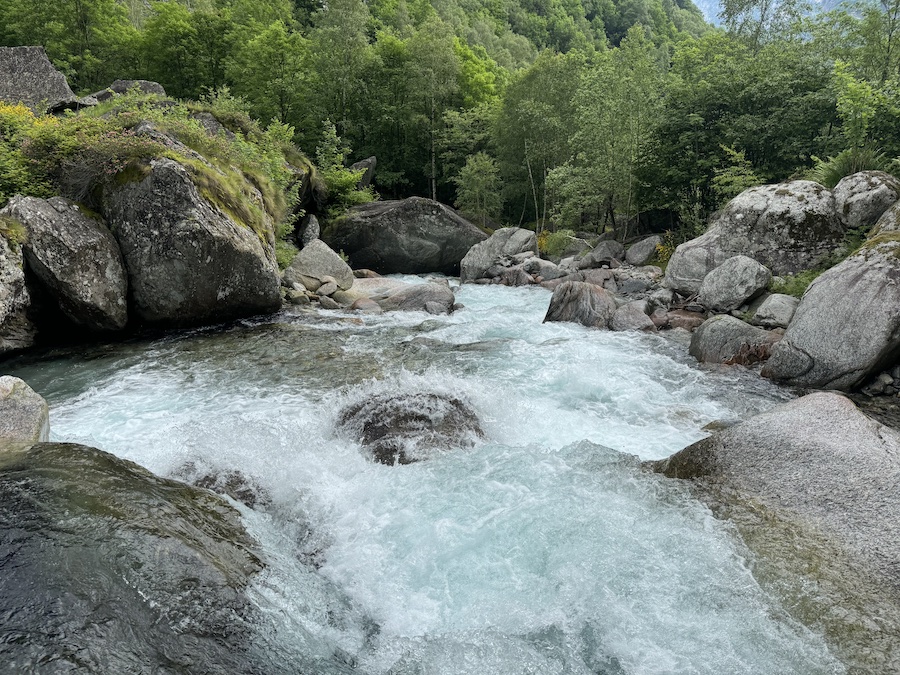 Crystal-clear water flowing between rocks near A Puntid.