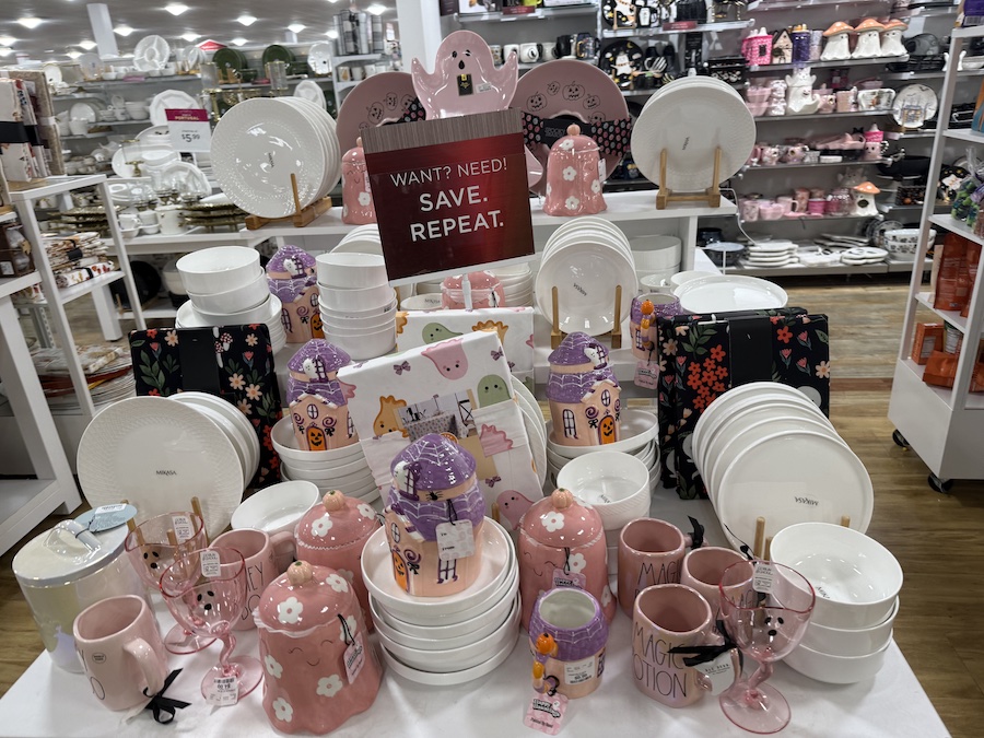 A vibrant display of whimsical and cute Halloween decor in a soft color palette of pink, purple, and white.