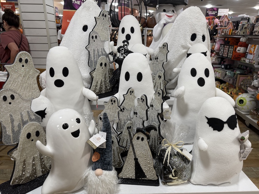 Plush and ceramic ghosts with smiling faces.