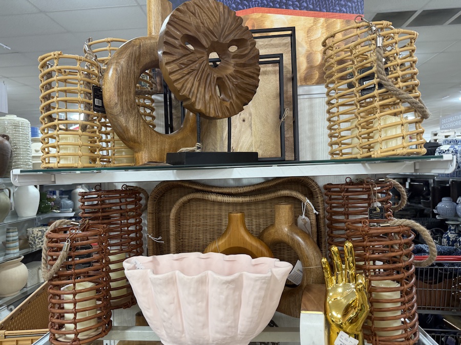 A shelf holds a collection of natural and rustic home decor.