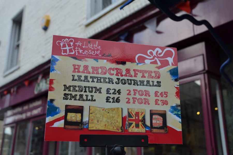 A close-up of a sign outside the souvenir shop "A Little Present".