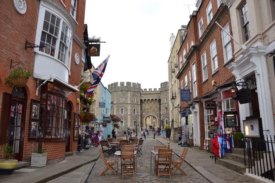 A view looking up a cobblestone street toward the entrance of Windsor Castle.