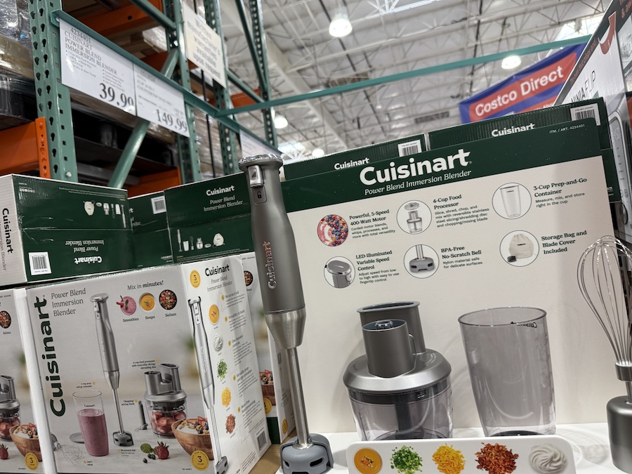 A display of Cuisinart Power Blend Immersion Blenders neatly stacked on a Costco shelf in the kitchen appliance section.