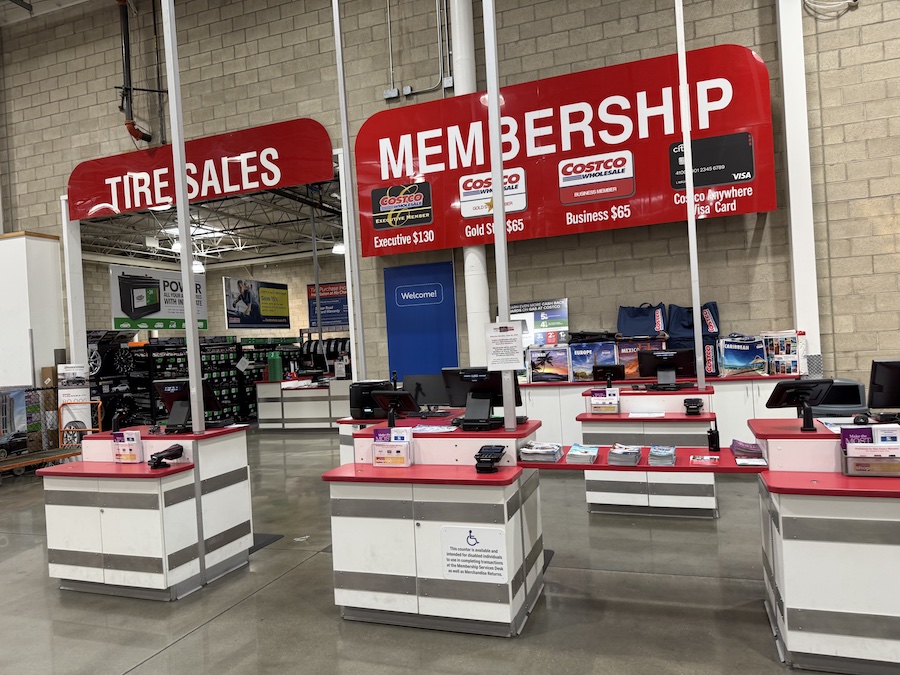 The Costco membership counter with banners highlighting Gold Star and Executive membership benefits.