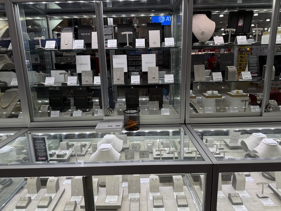 Diamond jewelry is displayed in a glass display case.