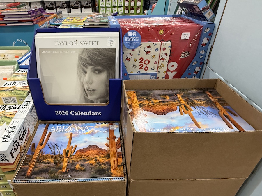 Calendars for 2026 are laid out in boxes near the books and stationery department.